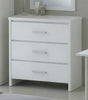 A white three-drawer dresser with slim silver handles, shown in a minimalist bedroom setting with a mirror and bedside table partially visible.