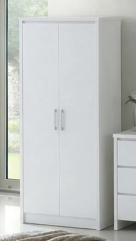 A tall white two-door wardrobe or armoire with slim silver handles, shown in a bright room next to a white three-drawer cabinet.