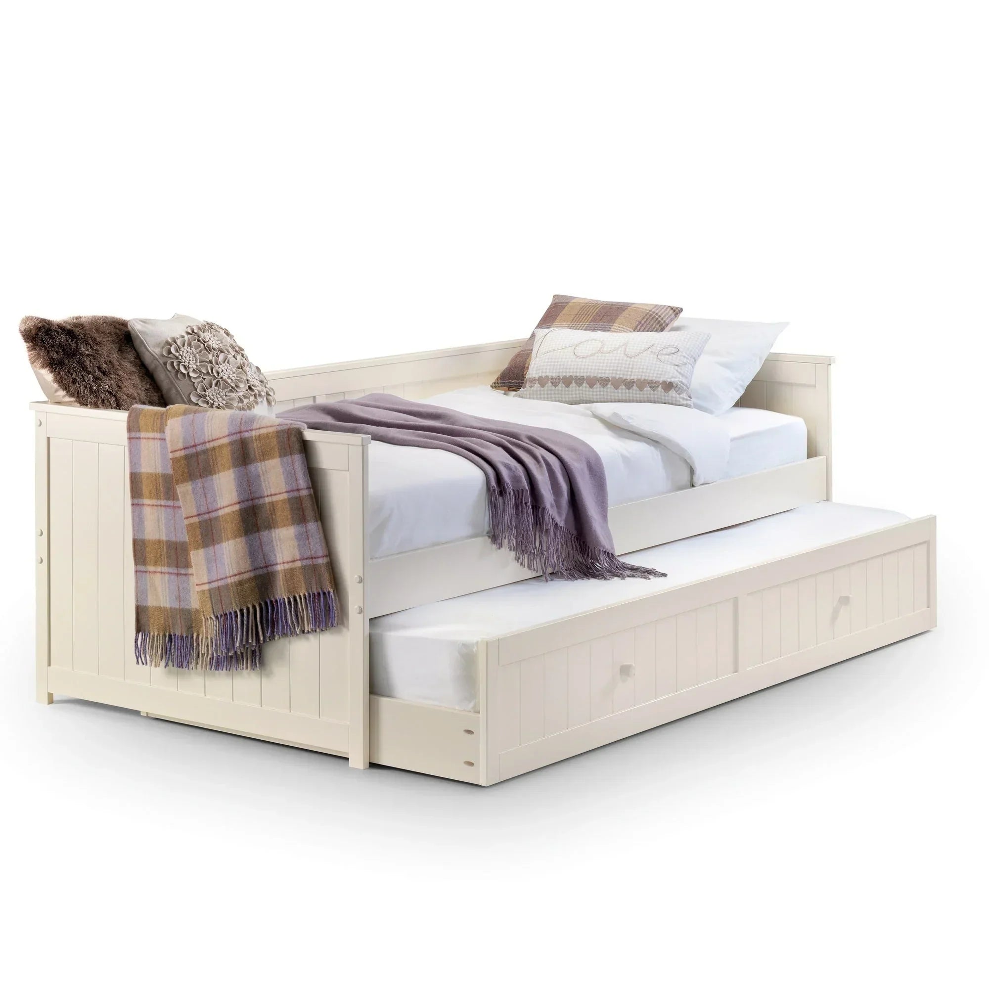 Cream single daybed with pull out trundle, styled with cushions and throw blanket