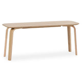Light wood dining table with rounded corners and angled legs on white background
