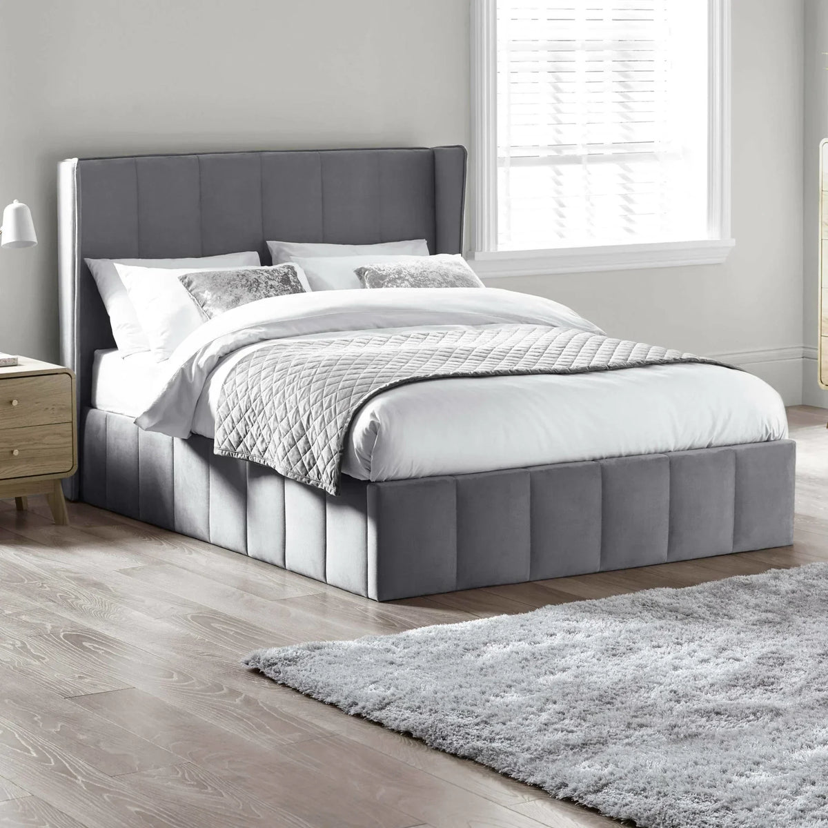 Grey upholstered bed frame with panel headboard in modern bedroom
