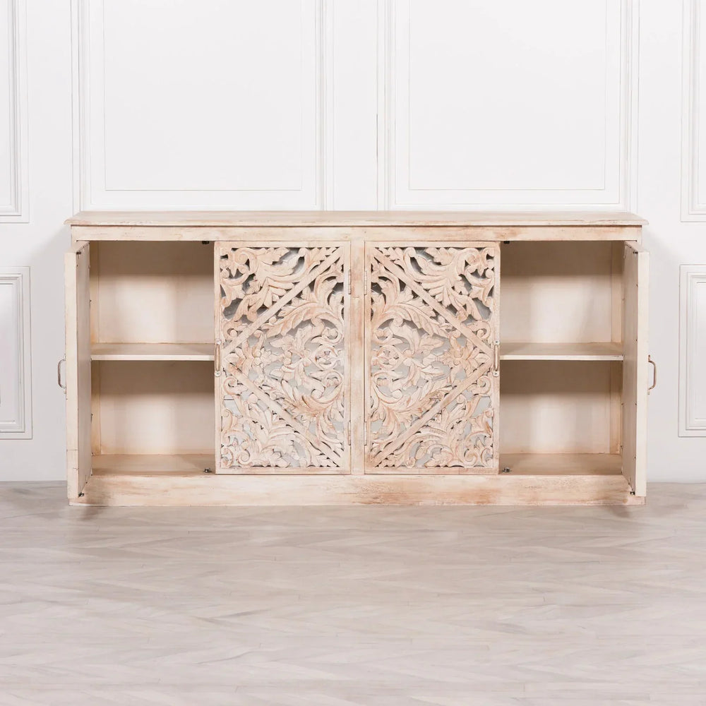 Carved wooden sideboard with sliding doors and open shelving in distressed light wood finish