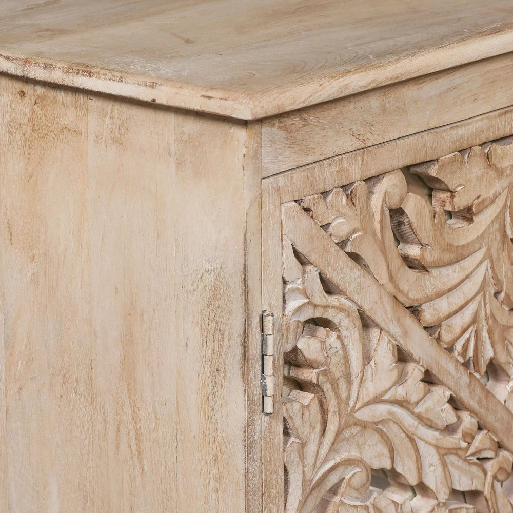 Carved wood cabinet door with floral detailing and natural finish, close-up view