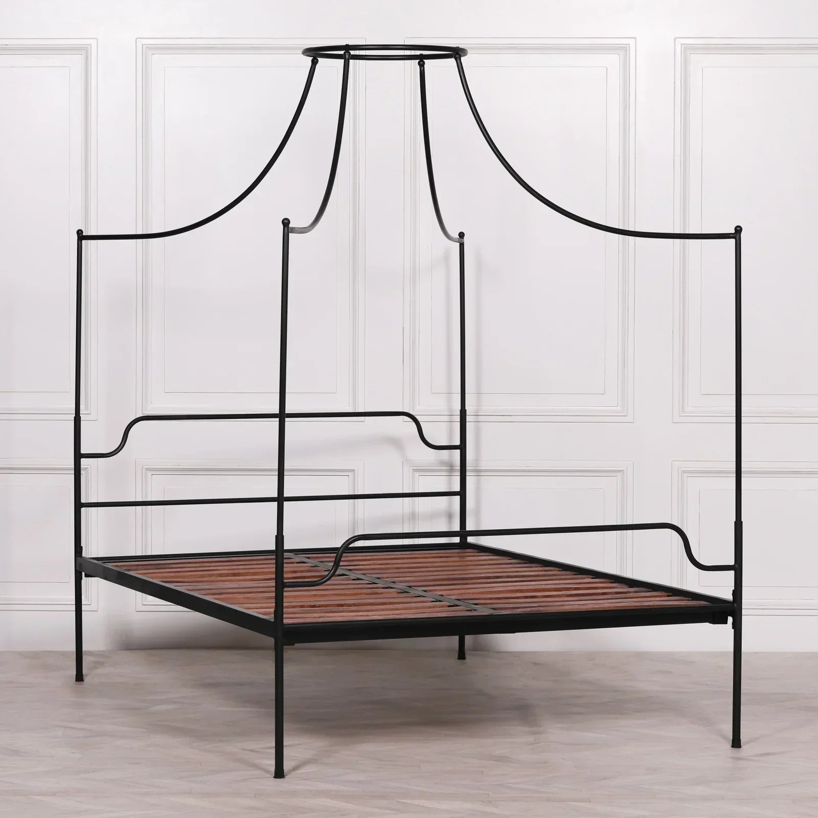 Black metal canopy bed frame with wooden slats in modern bedroom setting