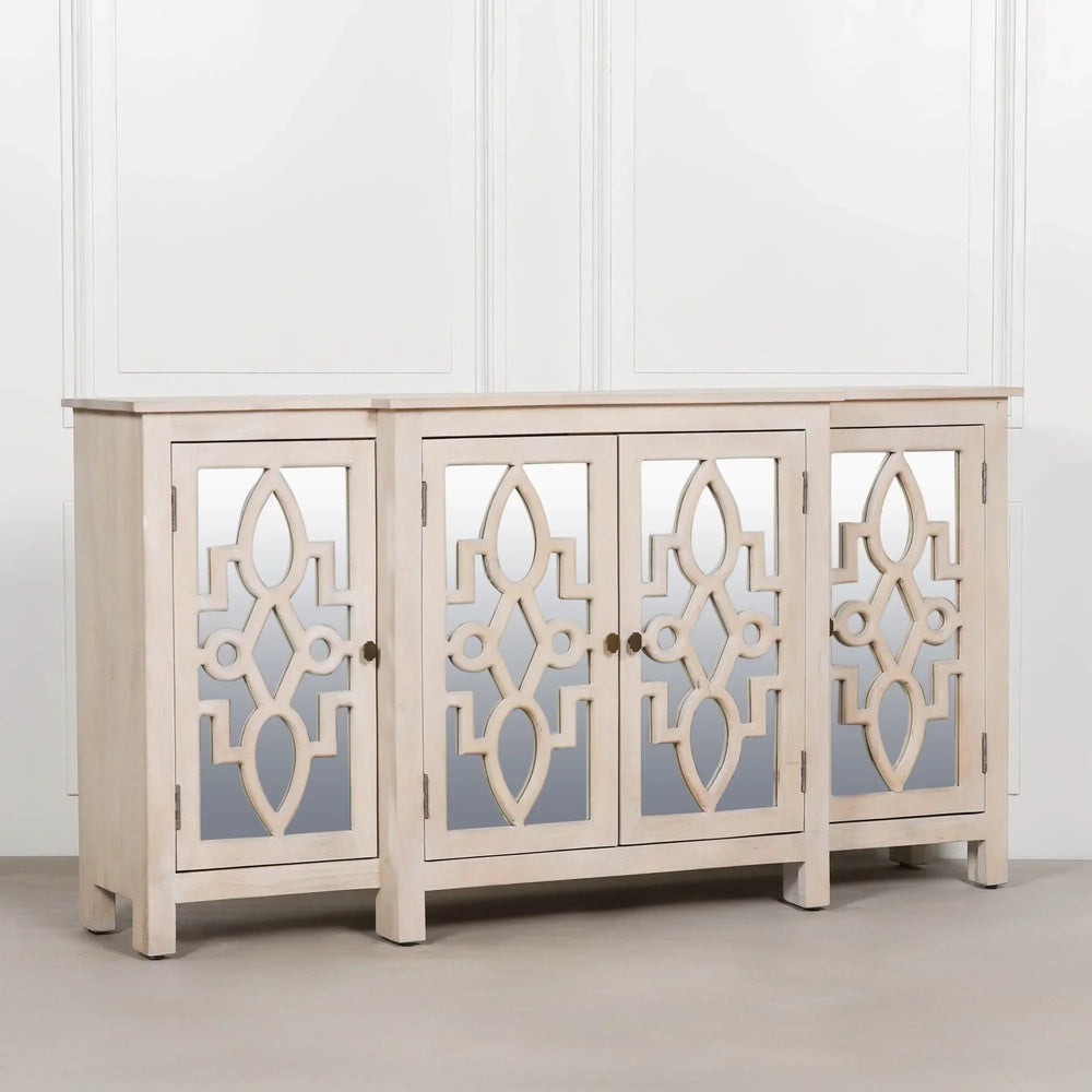 Light wood sideboard cabinet with mirrored geometric panel doors against white wall