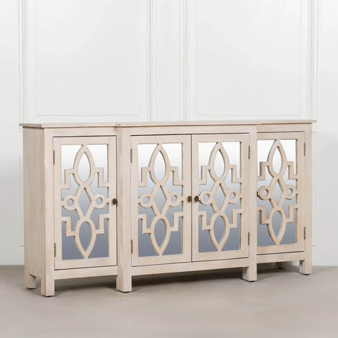 Light wood sideboard cabinet with mirrored geometric panel doors against white wall