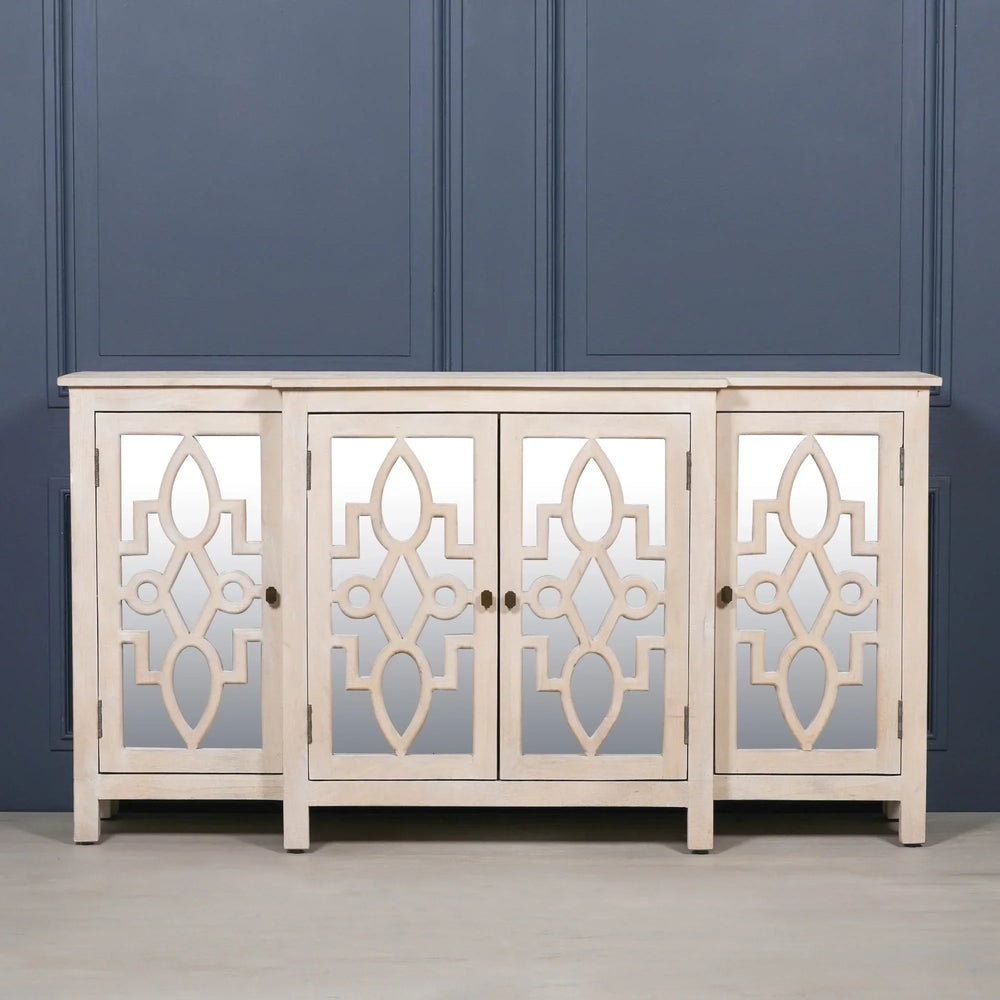 Four door mirrored sideboard with geometric wood pattern and light finish against blue wall