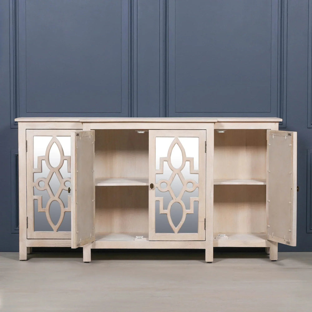 Light wood sideboard with mirrored doors open, showing two internal shelves against blue wall