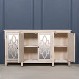 Light wood sideboard with mirrored doors open, showing two internal shelves against blue wall