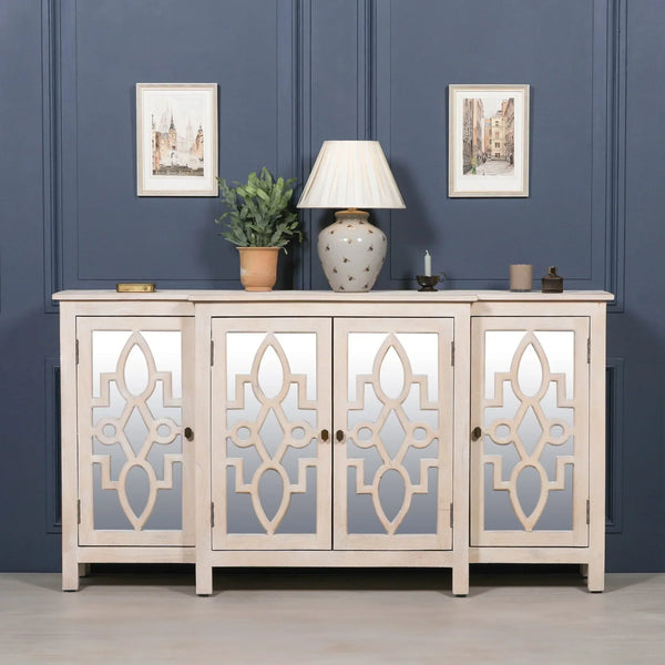 Mirrored sideboard with geometric wood doors, decorative lamp and plant on top