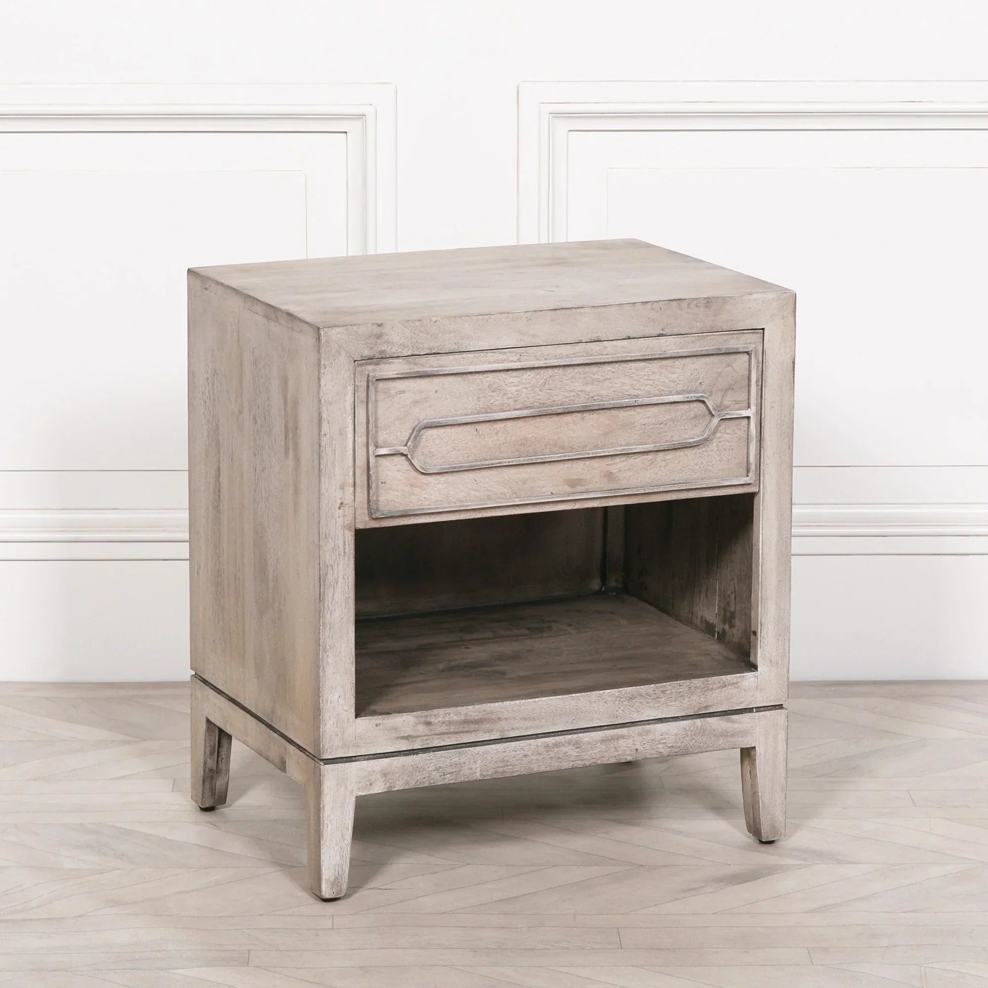 Rustic wood bedside table with single drawer and open shelf on light flooring