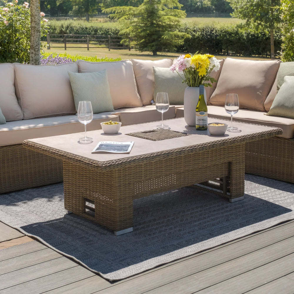 Rattan outdoor corner sofa set with beige cushions and rectangular garden table on patio