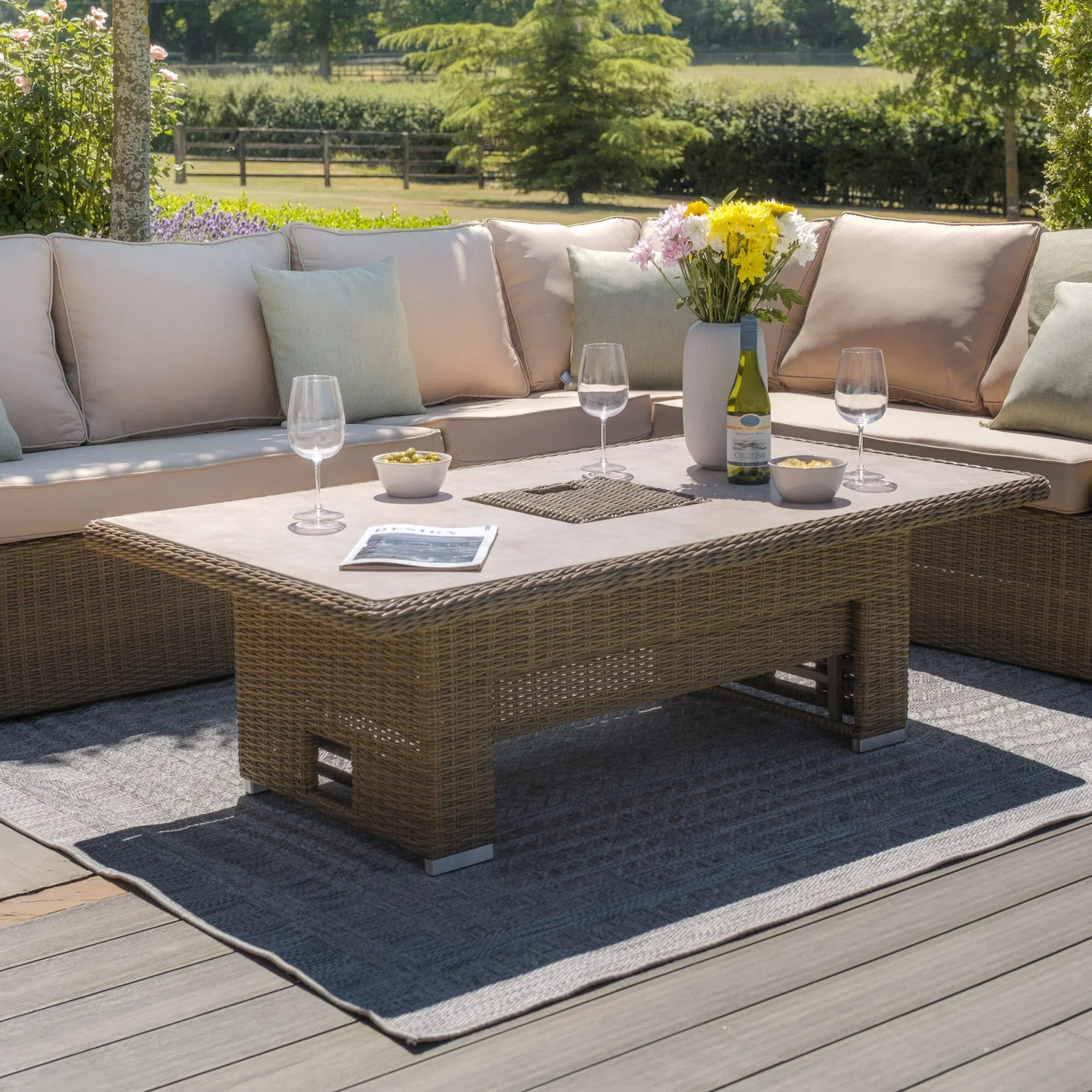 Rattan outdoor corner sofa set with beige cushions and rectangular garden table on patio