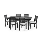 Black extending rectangular dining table with six black chairs with white upholstered seats and woven backrest
