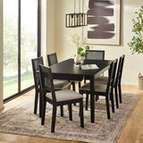 Black dining table with six chairs in bright room on patterned rug near window with pendant lights and wall art