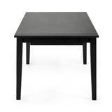 Black dining table with extension panel partially lifted, showing mechanism under tabletop