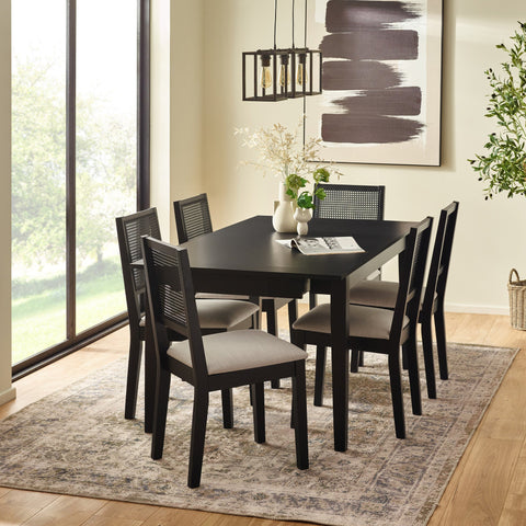 Dining room with six dark wood dining chairs around a matching rectangular table, light wall art and pendant lighting