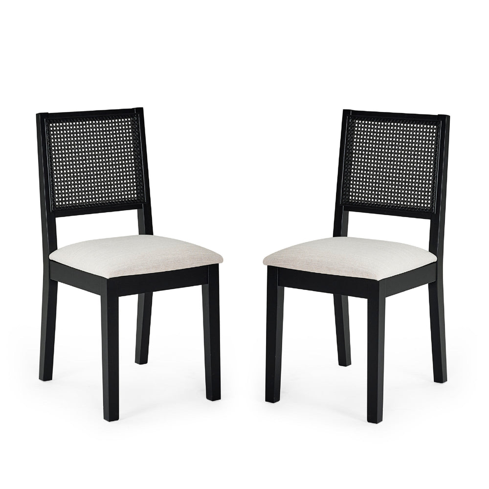 Pair of black wood dining chairs with woven cane backs and beige upholstered seats on white background.