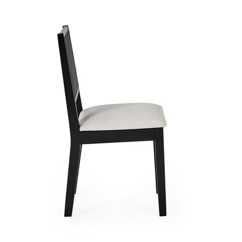 Side view of black wooden dining chair with woven cane backrest and cushioned light beige seat