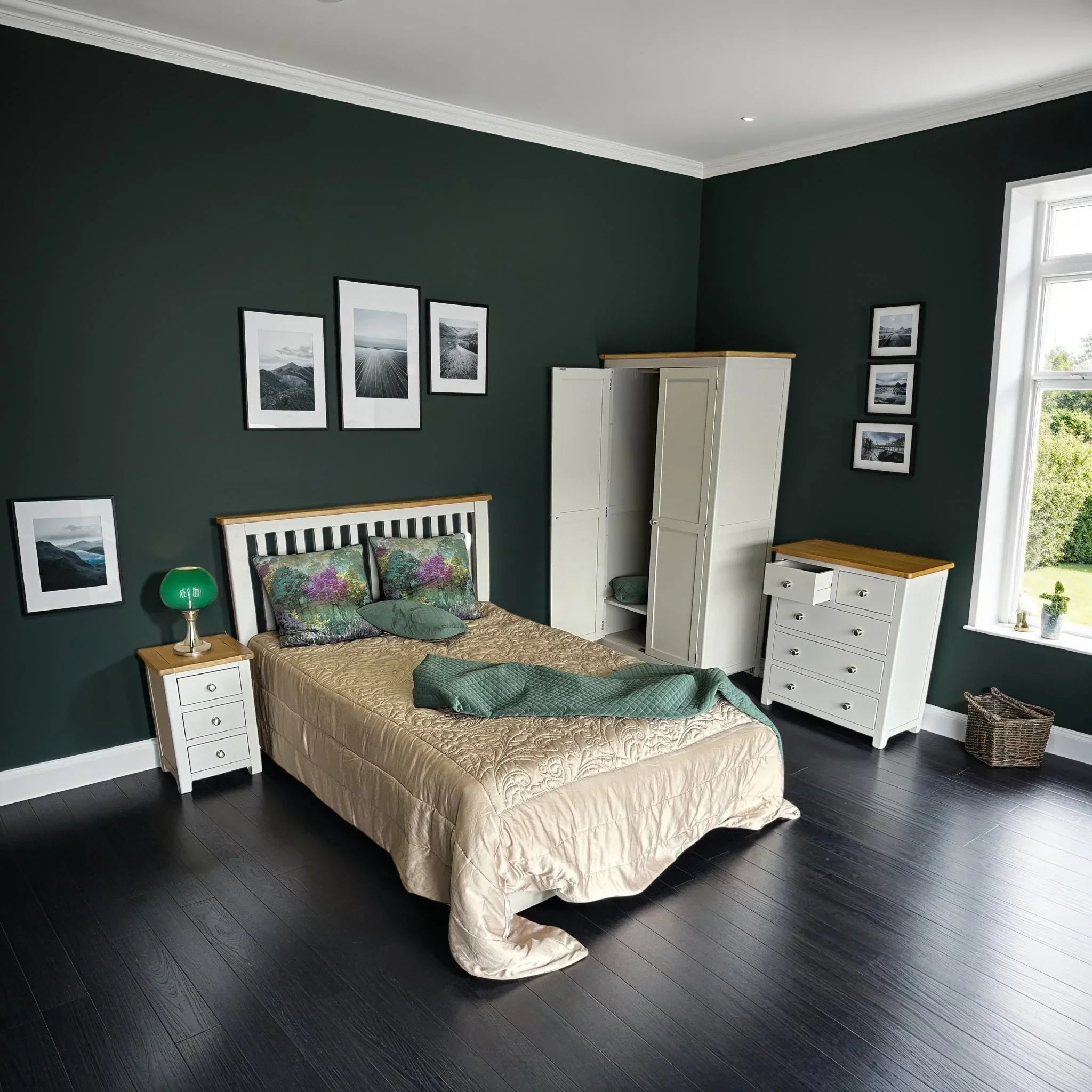 White bedroom furniture set with wardrobe, chest of drawers, and bedside table in bright room