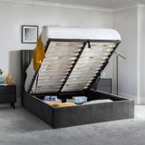 Grey ottoman storage bed with lifted frame showing underbed storage and bedroom décor