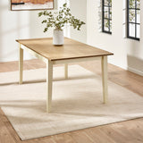 Rectangular dining table with light wood top and cream-colored tapered legs in bright room on beige rug