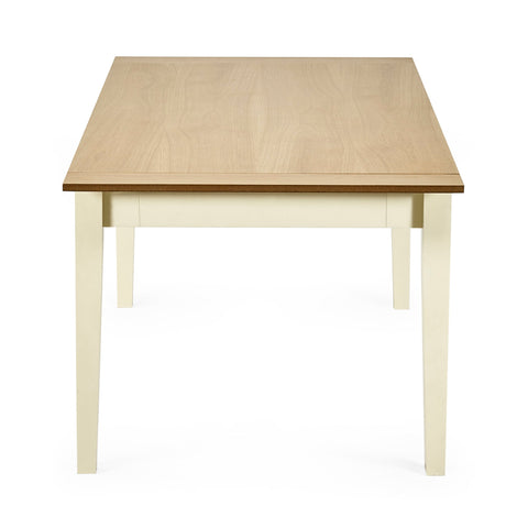 Rectangular dining table with light wooden top and cream square tapered legs viewed from the short side