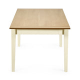 Rectangular dining table with light wooden top and cream square tapered legs viewed from the short side