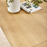 Close-up of smooth light wood grain tabletop with a white vase and rolled magazine on it
