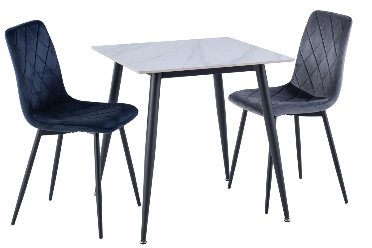 Velvet dining chairs with diamond stitching beside square white marble effect dining table