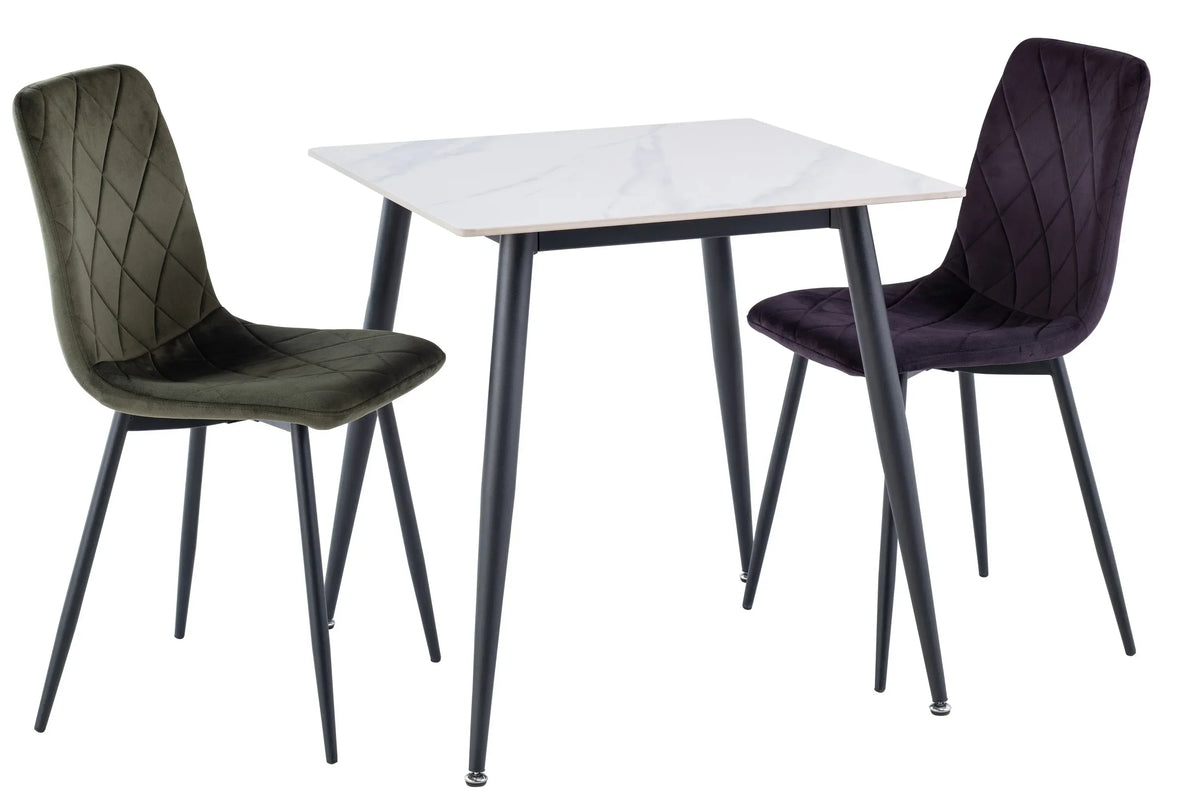 Modern marble dining table with green and purple velvet chairs, black metal legs