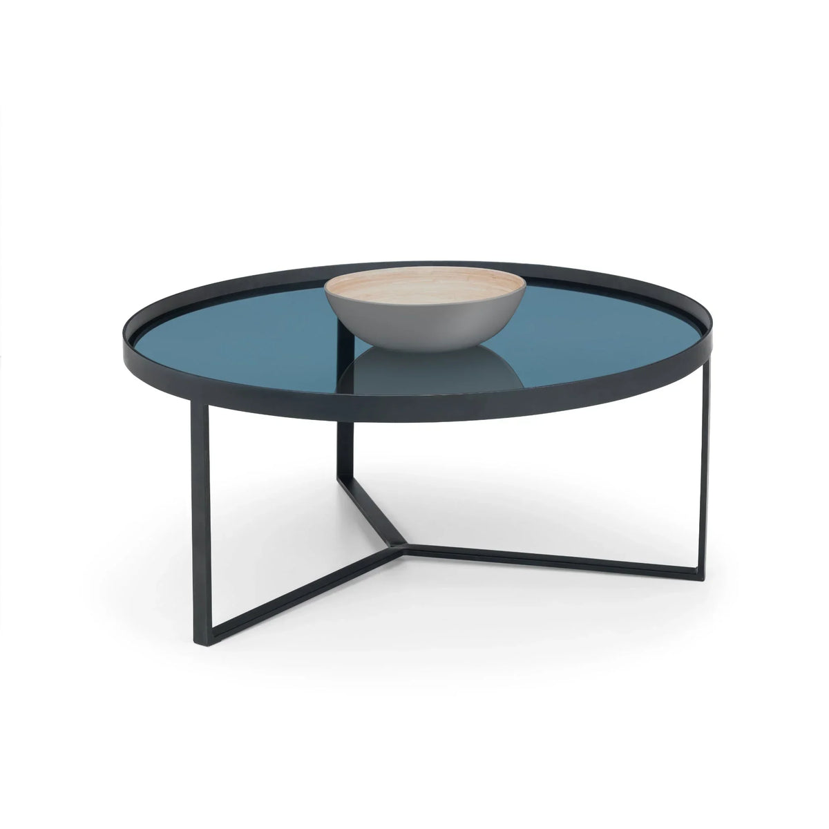 Round smoked glass coffee table with black metal frame and decorative bowl on top