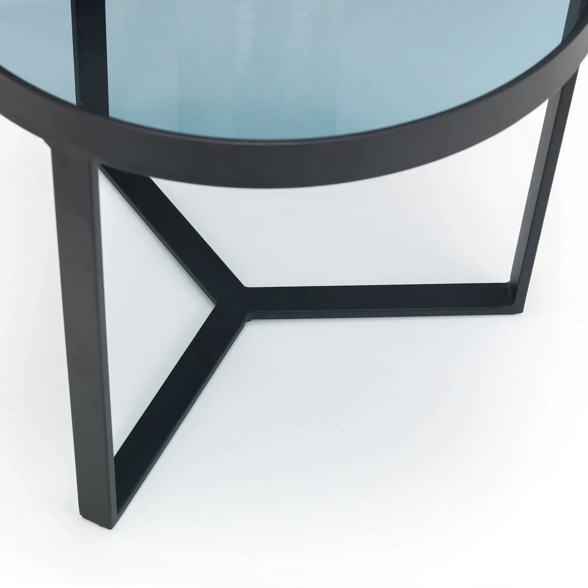 Smoked glass lamp table with black metal frame and angled legs, close-up detail view