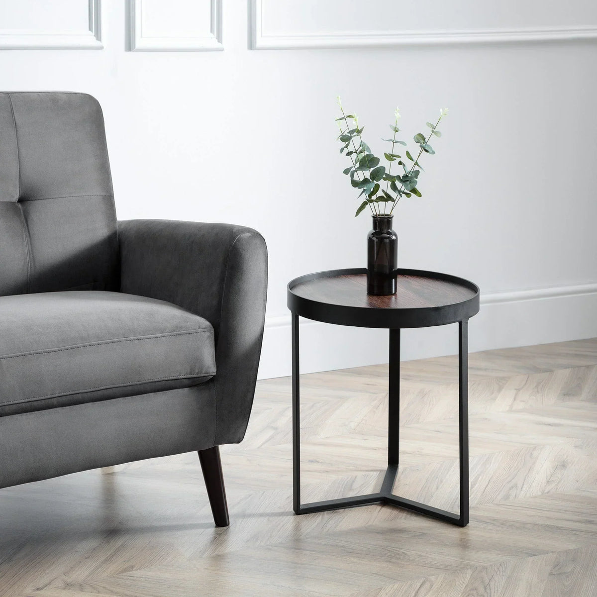 Loft walnut lamp table with black metal frame beside grey sofa on herringbone floor