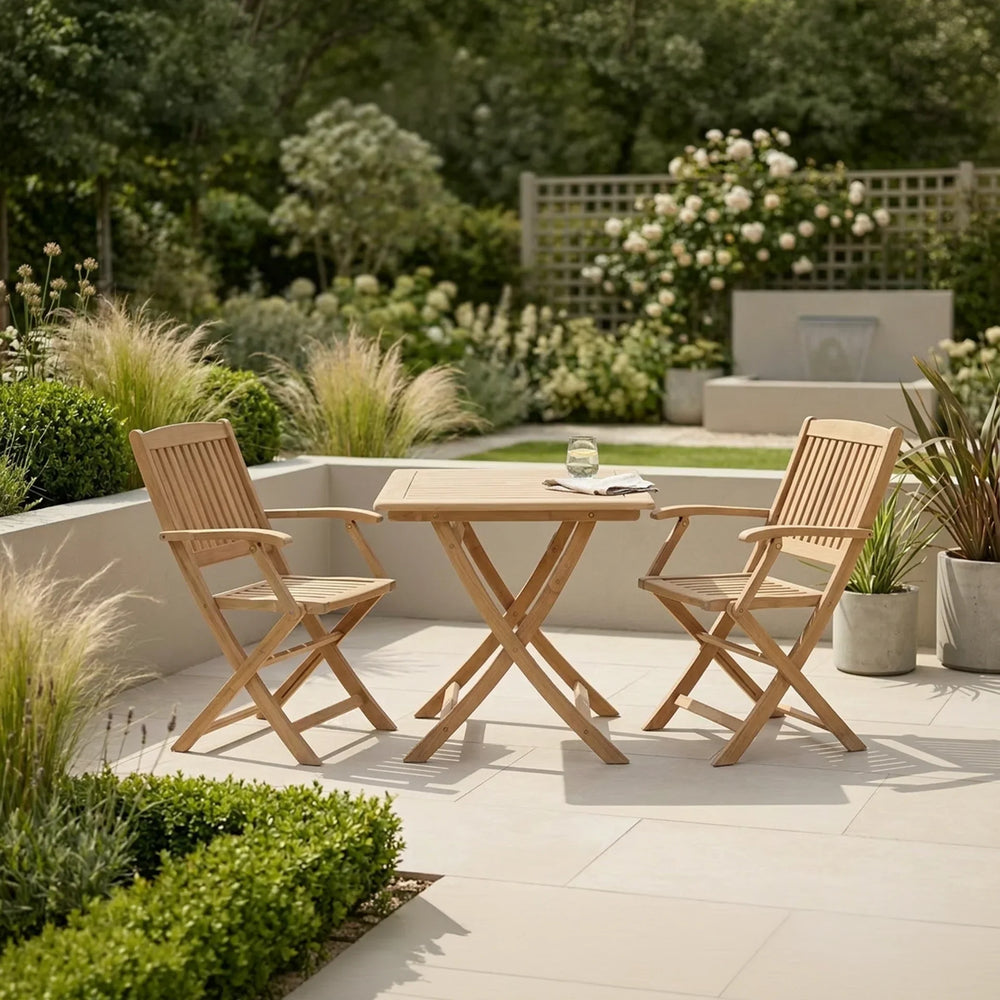 Wooden garden bistro set with folding chairs and table on patio, surrounded by greenery
