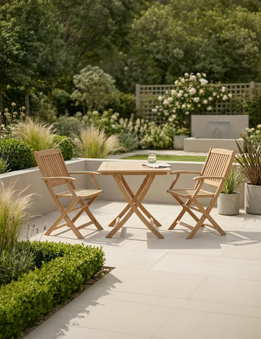 Wooden garden bistro set with folding chairs and table on patio, surrounded by greenery