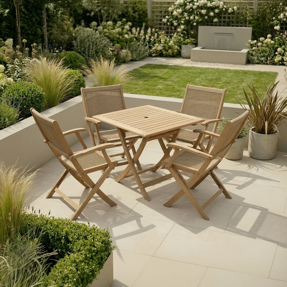Wooden garden dining set with four chairs on patio, surrounded by greenery and modern landscaping