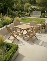 Wooden garden dining set with four chairs on patio, surrounded by greenery and modern landscaping