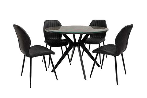 Round glass dining table with black metal legs and four matching black upholstered chairs