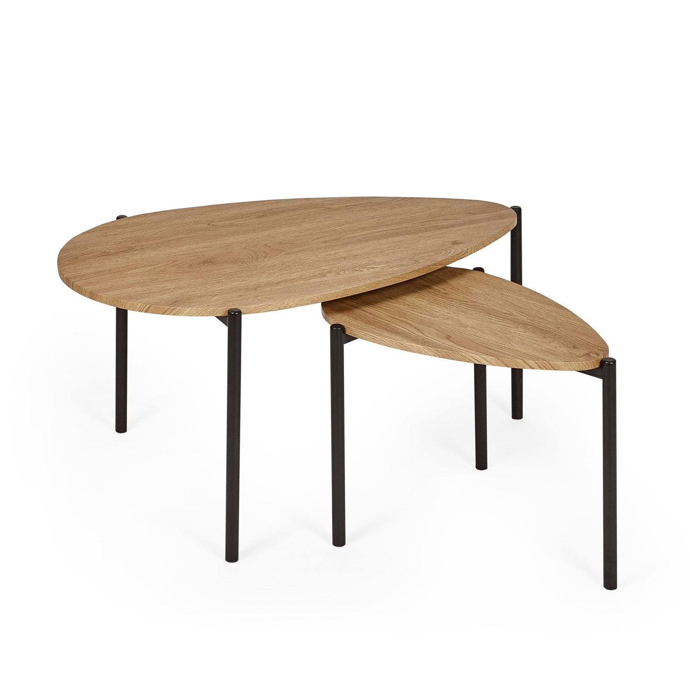 Top view of light oak wood teardrop nesting tables in living room with cup, candle, and books.