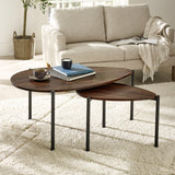 Dark wood nesting teardrop coffee tables with black metal legs in living room on light rug