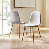 Pair of grey fabric dining chairs with wooden legs on herringbone floor in sunlit room