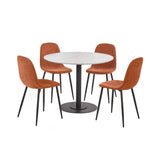 Round white marble dining table with black pedestal base and four orange upholstered chairs