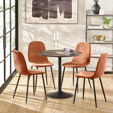 Modern dining table set with four orange fabric chairs and round black table