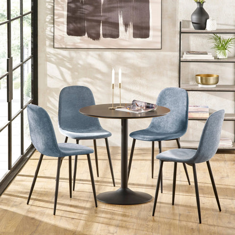 Round dining table set with four blue fabric chairs in modern dining room