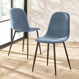 Pair of blue velvet dining chairs with black metal legs on wooden floor