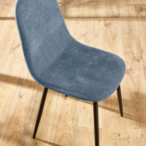Blue fabric dining chair with curved seat and black legs on wooden flooring