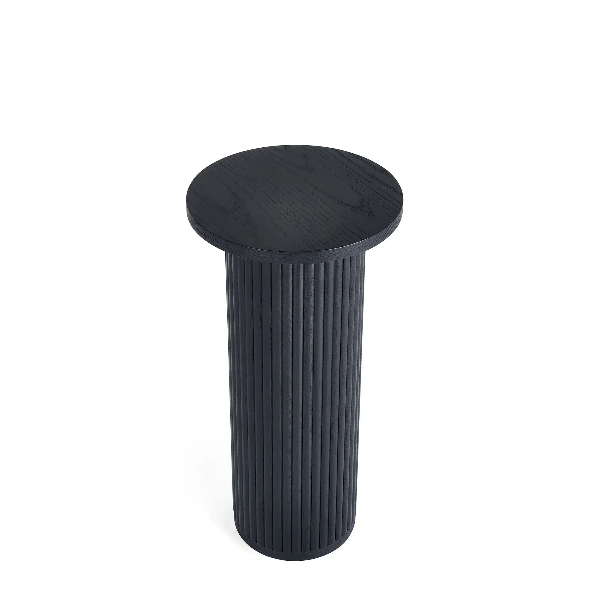 Black fluted drinks table with round top and vertical grooved base on white background
