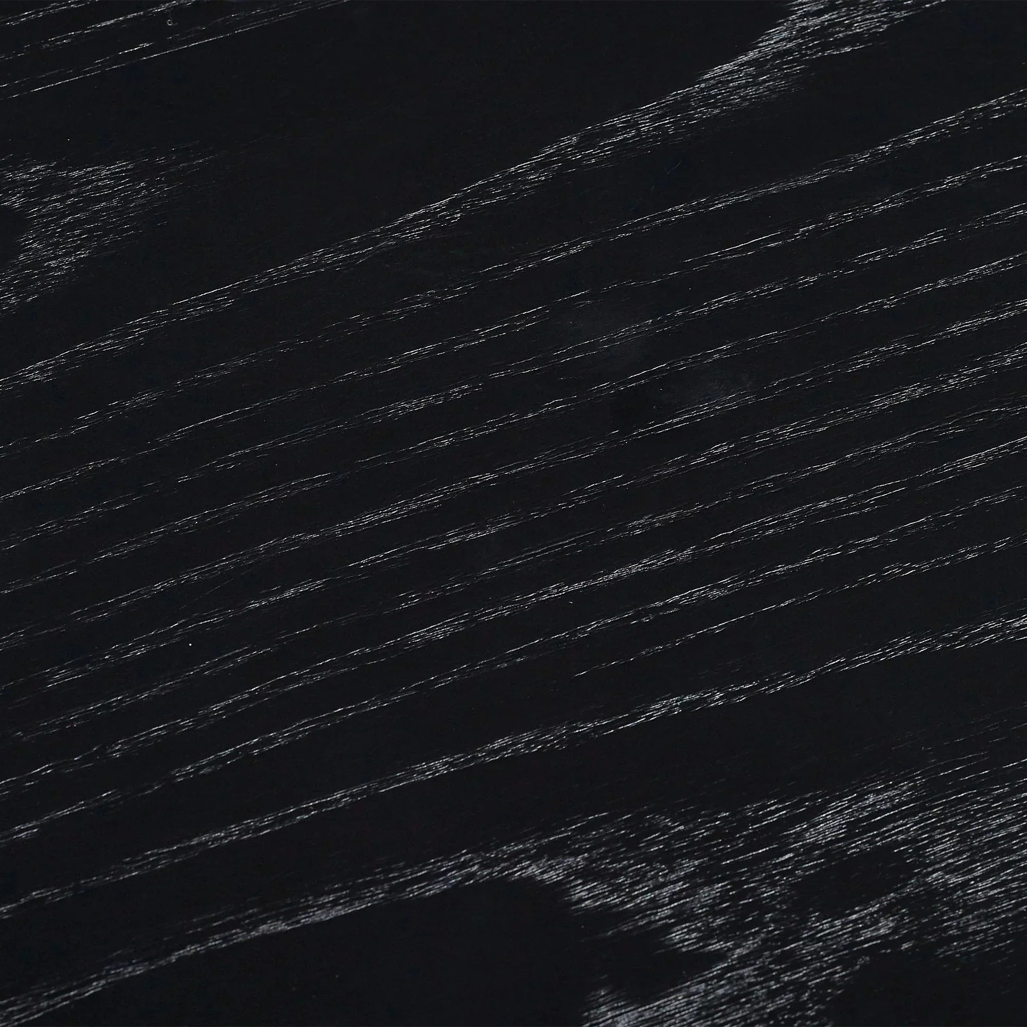 Black fluted drinks table close-up showing wood grain texture detail