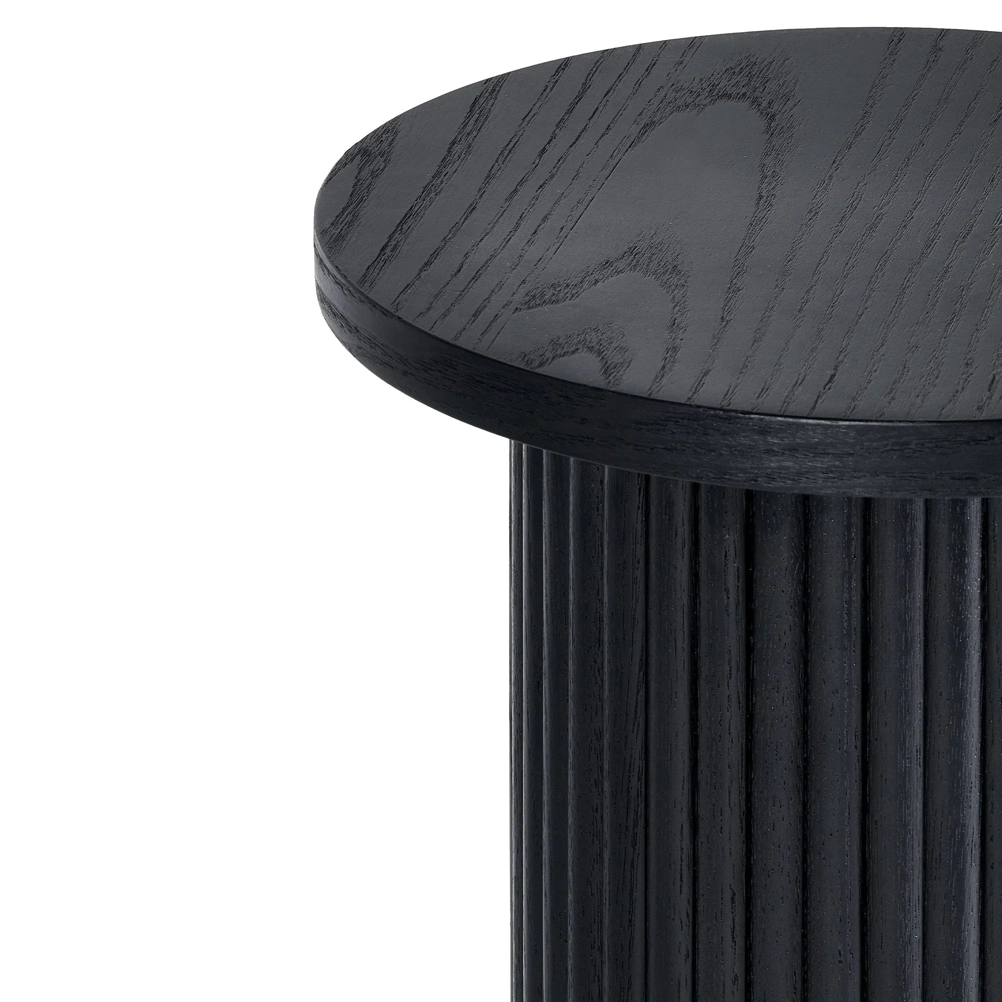 Closeup of black fluted drinks table showing textured round top and vertical ribbed base